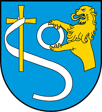 Herb gminy Gołymin-Ośrodek przedstawia w polu błękitnym krzyż złoty opleciony srebrną szarfą w literę S a na lewo pół lwa złotego, który dzierży w łapach srebrną obręcz - Prawdę.
